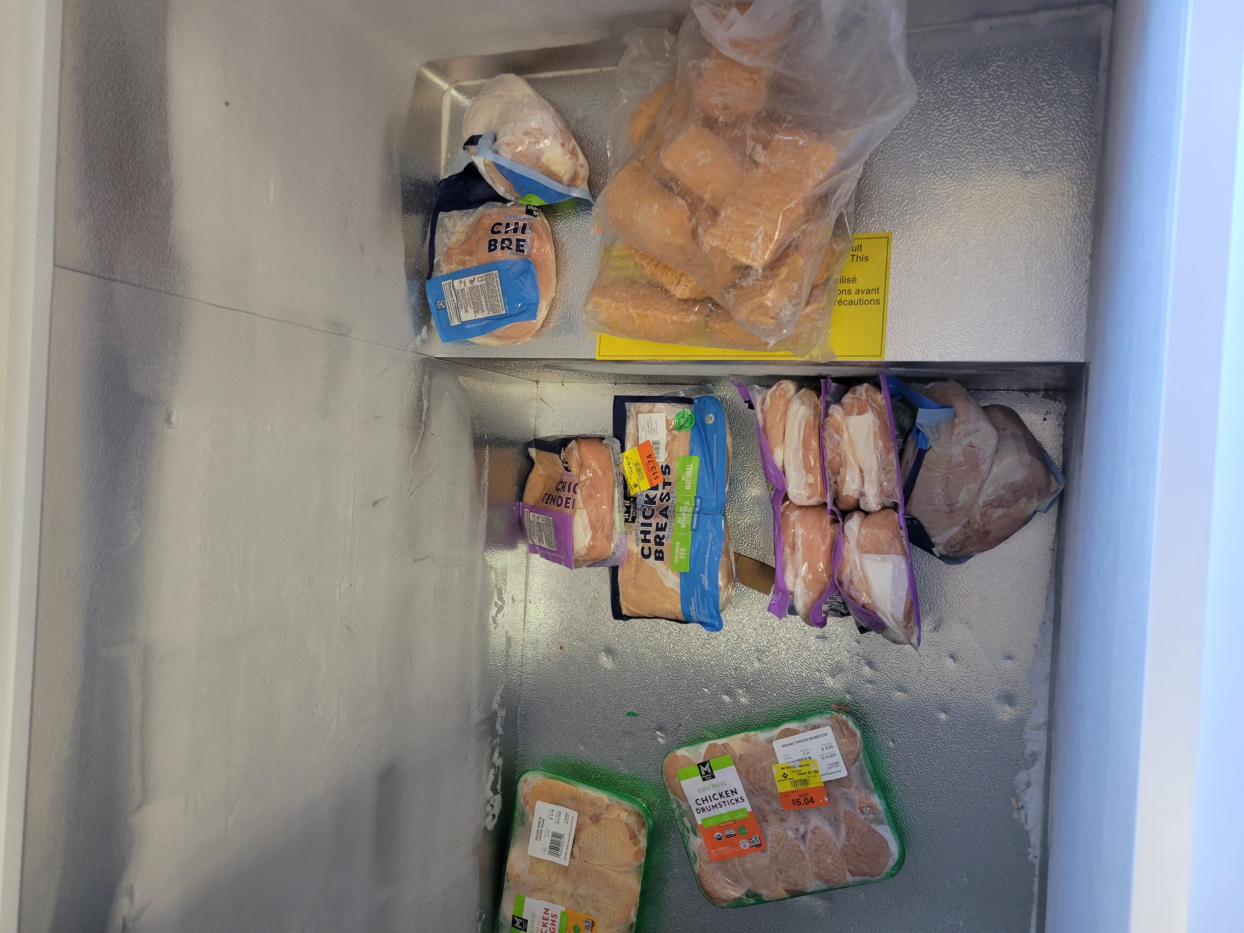 Different cuts of chicken in a freezer.